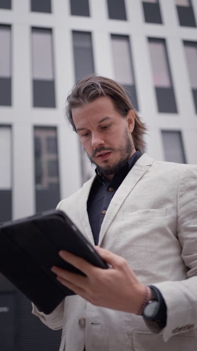 Businessman Immersed In Digital World During Urban Walk