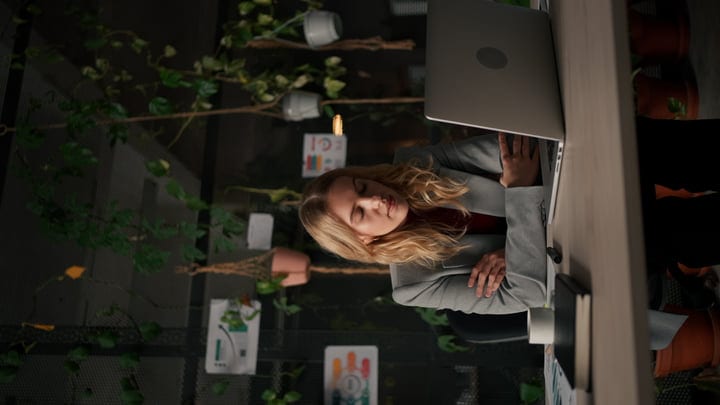 Focused Businesswoman Engaged With Work In Her Green Office