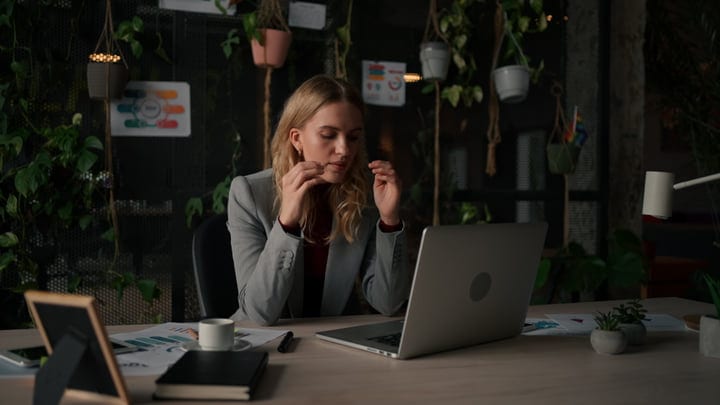 Focused Businesswoman Engages in Virtual Meeting at Home Office