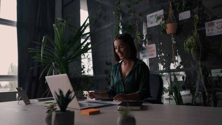 Focused Businesswoman Working in Modern Green Office Environment