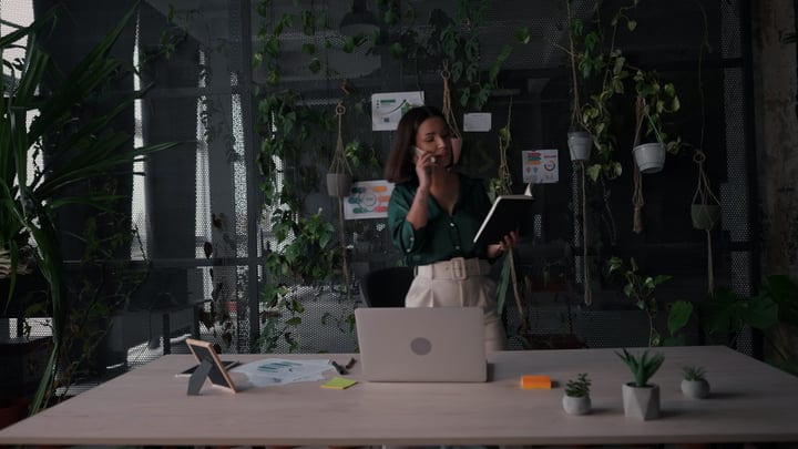 Modern Professional Engages in Office Dialogue Amid Greenery