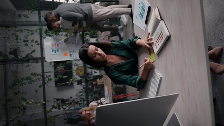 Focused Businesswoman Planning in a Green Office Setting