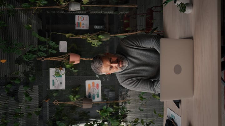 Focused Businessman in Modern Office with Green Decor