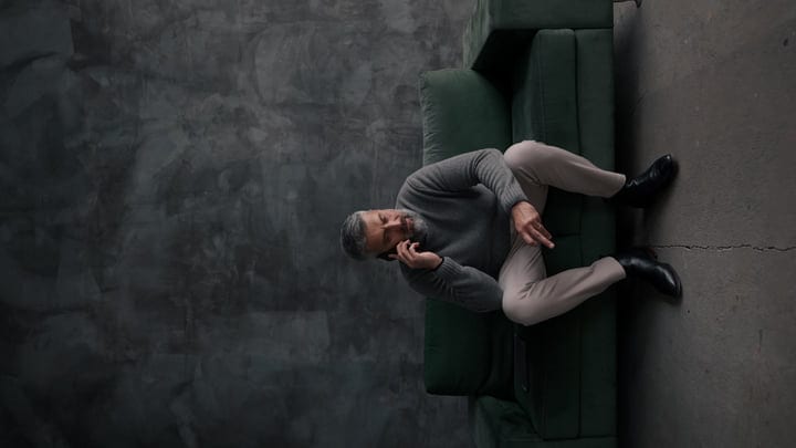 Businessman Balances Work and Comfort on a Green Sofa