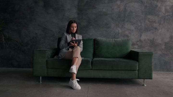 Contemplative Businesswoman Writes Ideas On A Tablet