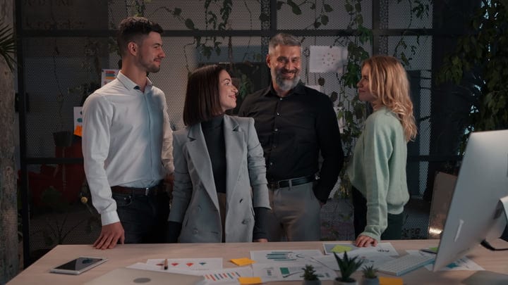 Colleagues Share A Laugh In A Modern Office Setting