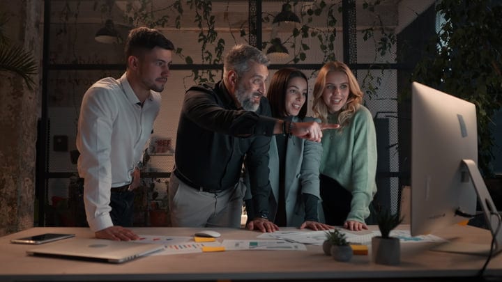 Collaborative Teamwork Illuminates Ideas In A Modern Office
