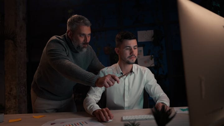 Mentorship Blossoms Under The Glow Of Office Lights