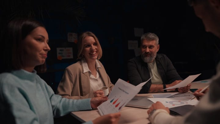 Collaborative Teamwork Illuminated By Warm Office Light