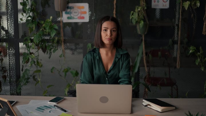 Focused Businesswoman Engaging in Deep Thought at Her Desk