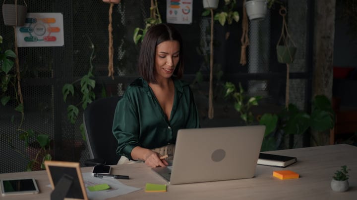 Confident Businesswoman Engaged In Creative Office Work