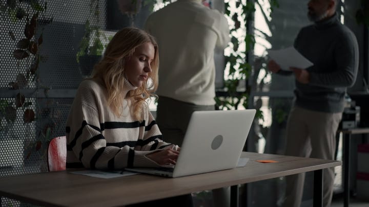 Focused Businesswoman Typing in a Contemporary Office Setting
