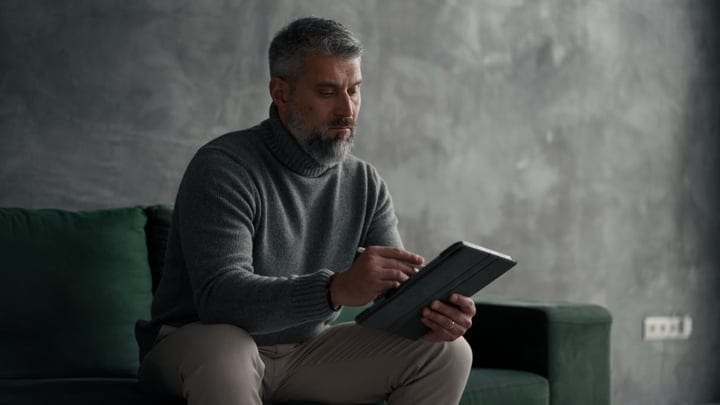Focused Businessman Engaging with Technology in Modern Setting