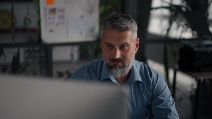 Focused Businessman Engaging With His Work In Modern Office