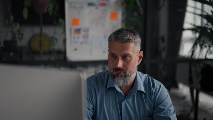 Focused Professional Immersed In Thoughtful Office Work