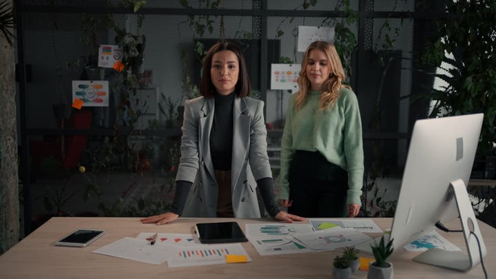Confident Businesswomen Strategize in a Modern Office Space
