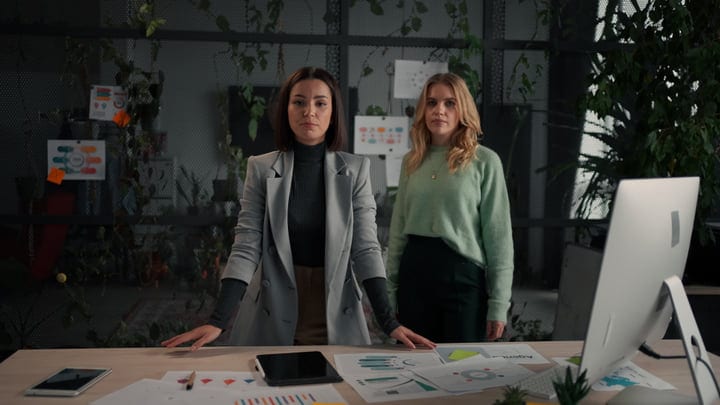Two Professionals Strategize In A Modern Office Setting