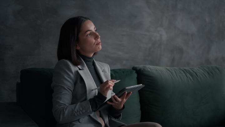 Focused Businesswoman Strategizes With Tablet In Modern Office