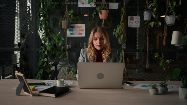 Focused Businesswoman Working in a Green Office Environment