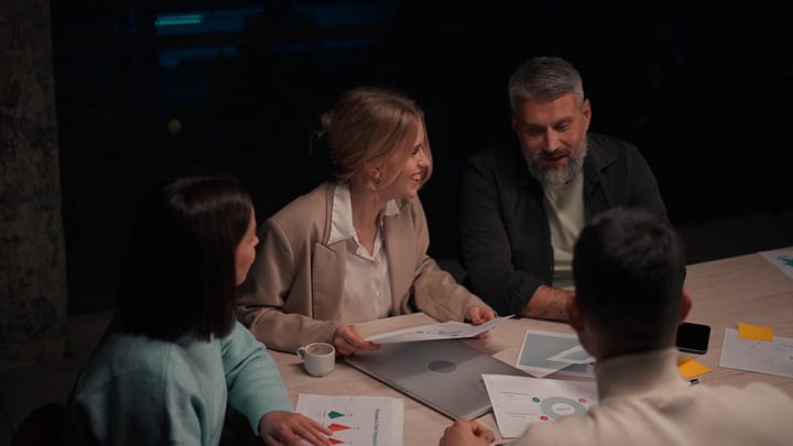 Lively Business Meeting Illuminated By Warm Office Lights