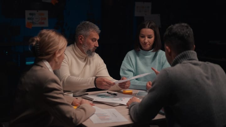 Collaborative Minds Engaged In Evening Office Strategy