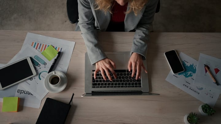 Focused Female Professional Typing in a Modern Office