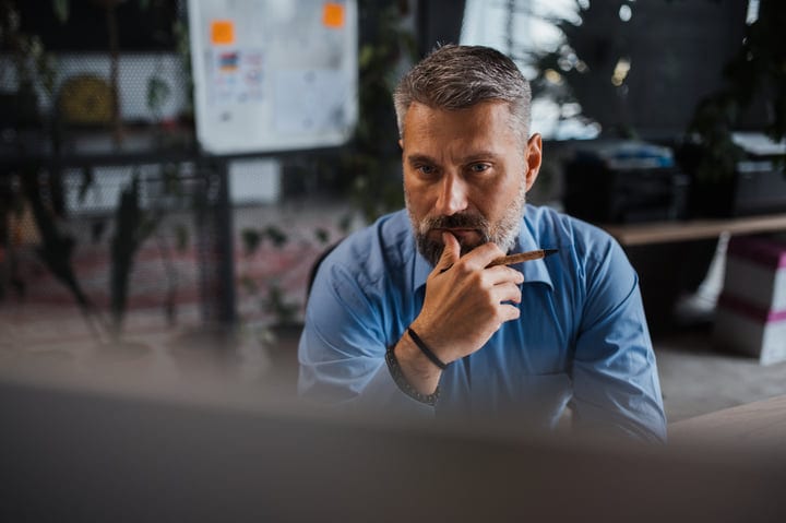 Businessman Contemplates Strategy in Modern Office Setting
