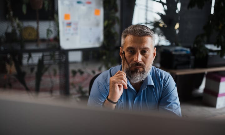Focused Businessman Contemplates Strategy In Modern Office