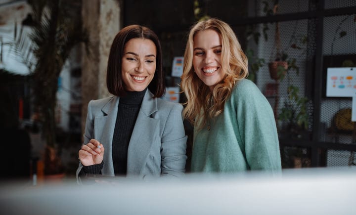Two Professionals Share a Moment of Joy at Work