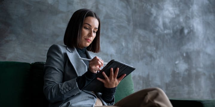 Focused Businesswoman Engages with Tablet in Modern Office