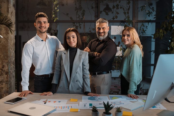 Confident Team Embraces Collaborative Spirit In Modern Office