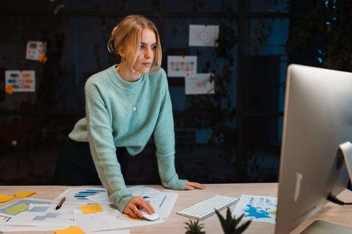 Focused Businesswoman Analyzing Data In Modern Office