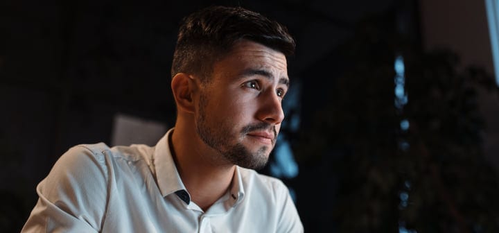 Focused Professional Engaged in Thoughtful Evening Planning