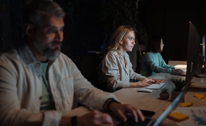 Focused Businesswoman Typing Late At Night In Modern Office
