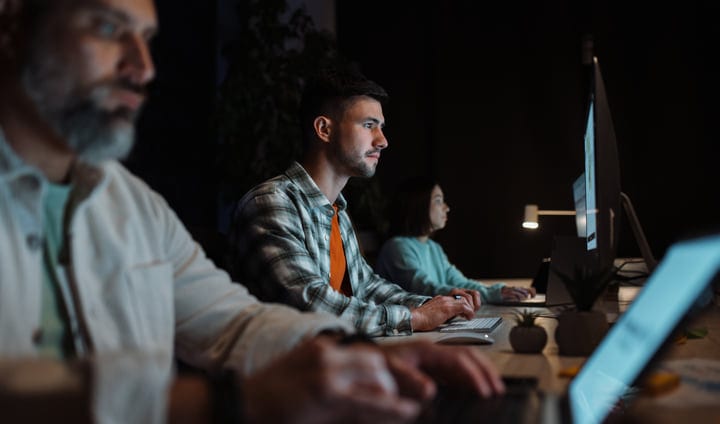 Focused Professionals Collaborate Late Into The Night