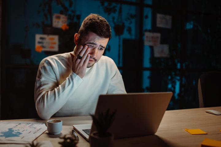 Late-Night Focus: Businessman Works Under Dim Light