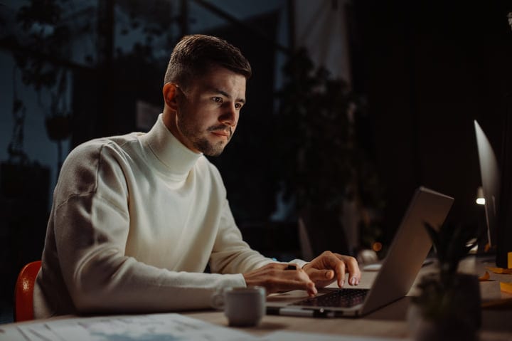 Focused Professional Working Late Night in Cozy Office