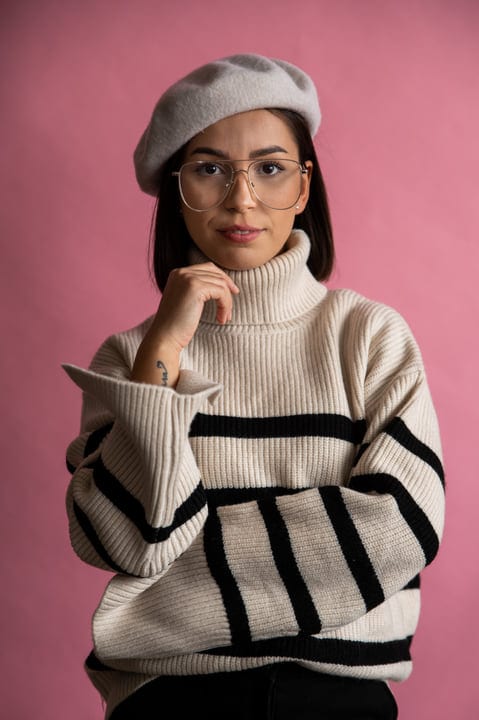 Confident Businesswoman Embraces Casual Style in Pink Setting
