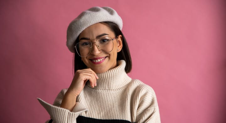 Smiling Businesswoman Embracing Confidence Against Pink Backdrop
