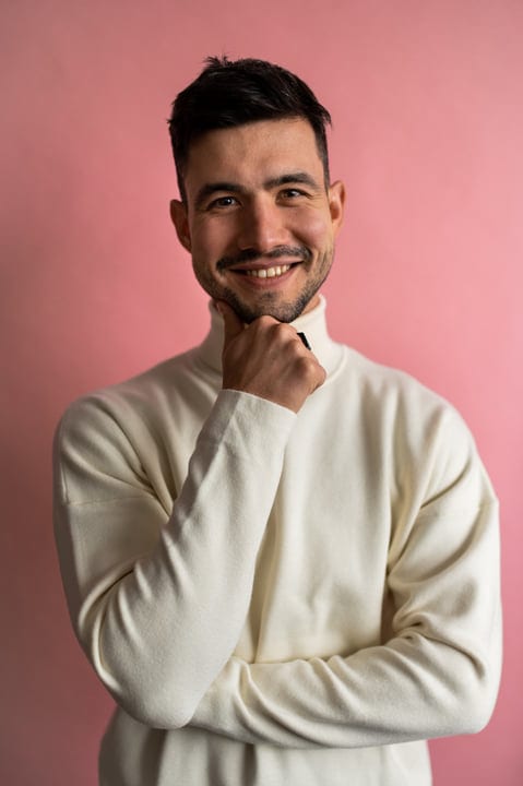 Thoughtful Businessman Reflects Against a Pink Backdrop