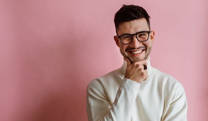 Confident Smile Against a Vibrant Pink Background