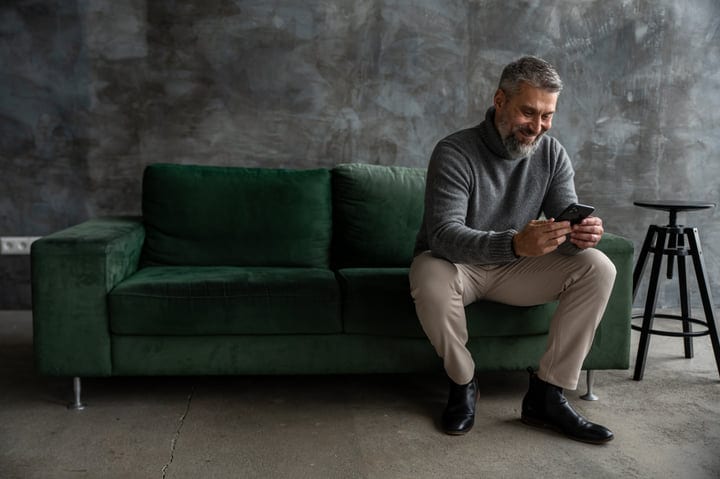 Thoughtful Businessman Engages with Mobile in Modern Office