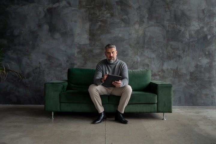 Focused Professional Man Contemplating On A Modern Sofa