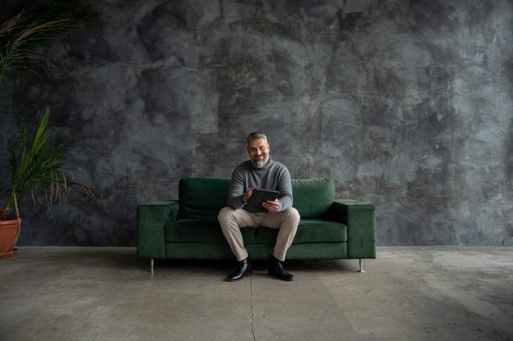 A Professional Finds Solace On A Green Couch