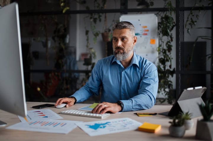 Focused Professional Analyzing Data In A Modern Office Environment