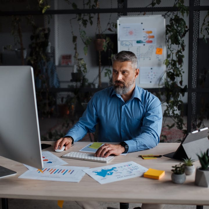 Focused Professional Analyzing Data In Modern Office Space