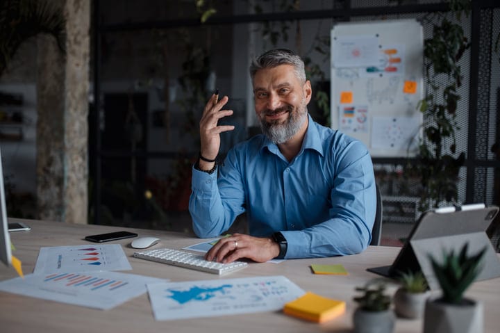Confident Professional Engages in Virtual Meeting at Office Desk