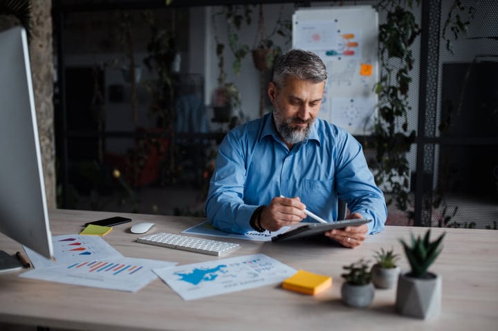 Focused Businessman Analyzing Data in Modern Office Space