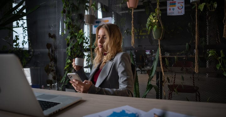 Reflective Pause With Coffee In A Green Office Oasis