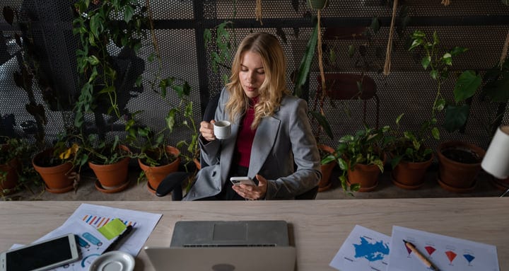 Businesswoman Balances Coffee and Conversations in Office Oasis